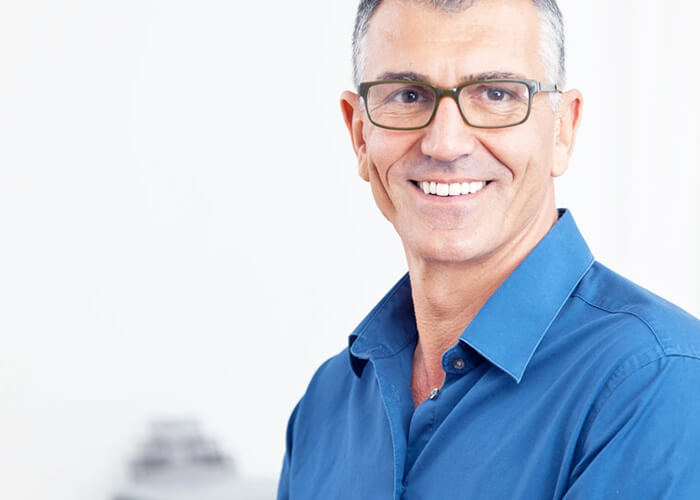A middle-aged man wearing glasses